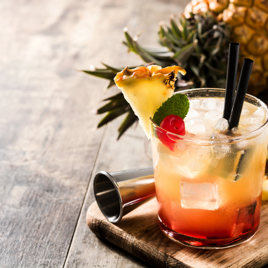 Tropical Drink with pinapple and cherry on a table