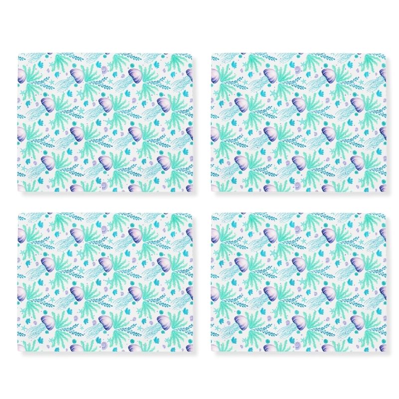 Four matching coastal placemats with an ocean-themed jellyfish pattern on a white background