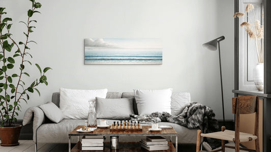 Beyond the Blue 16x48 coastal wall art above a sofa in a living room
