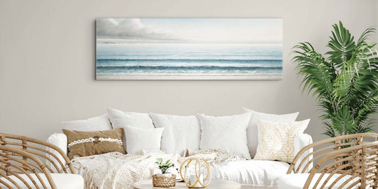 Coastal wall art for living room canvas hanging above a rattan sofa
