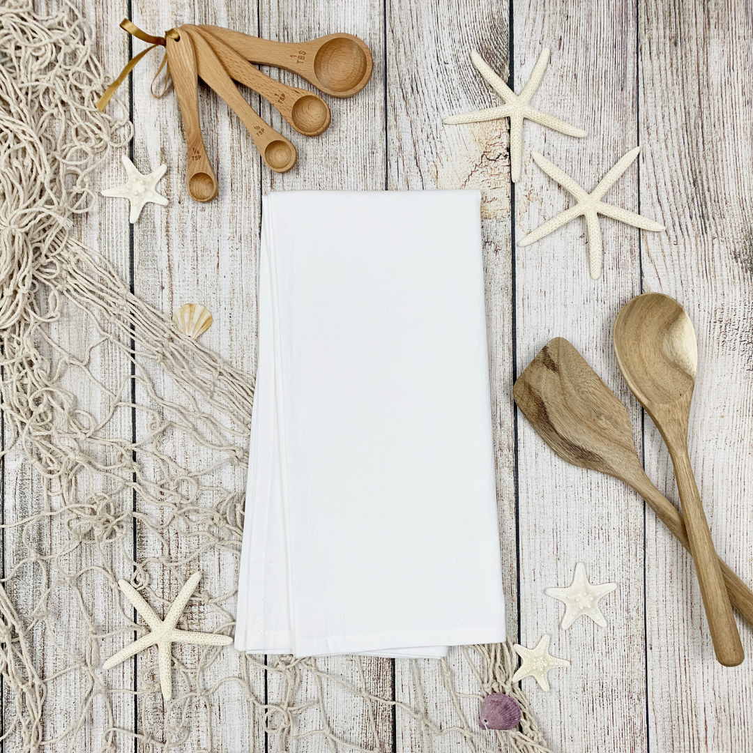 napkins, wooden spoons and starfish on a wooden table