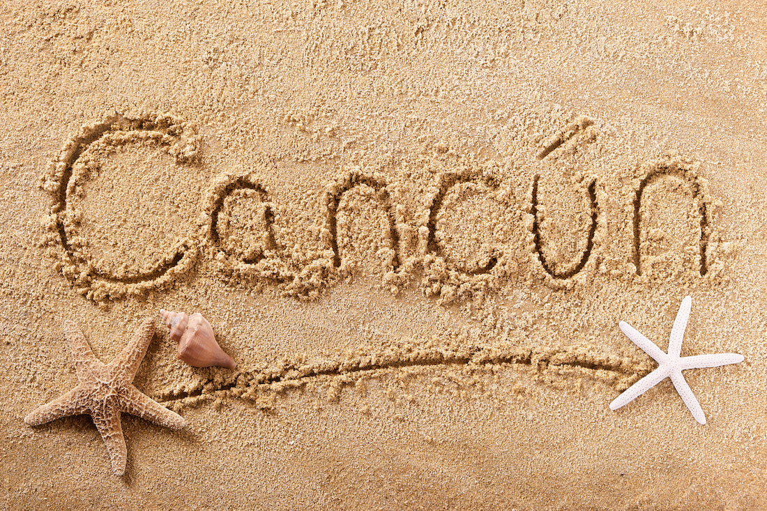 Cancun written in the sand