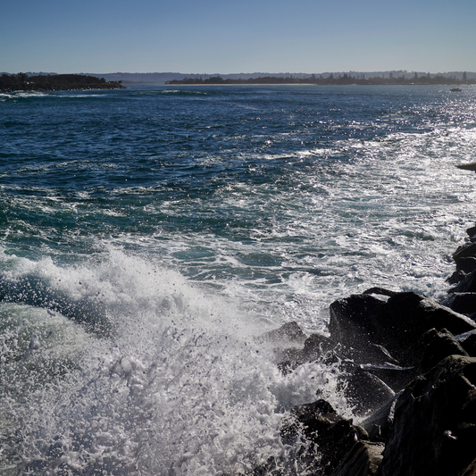 ocean waves crashing against a rocky shore