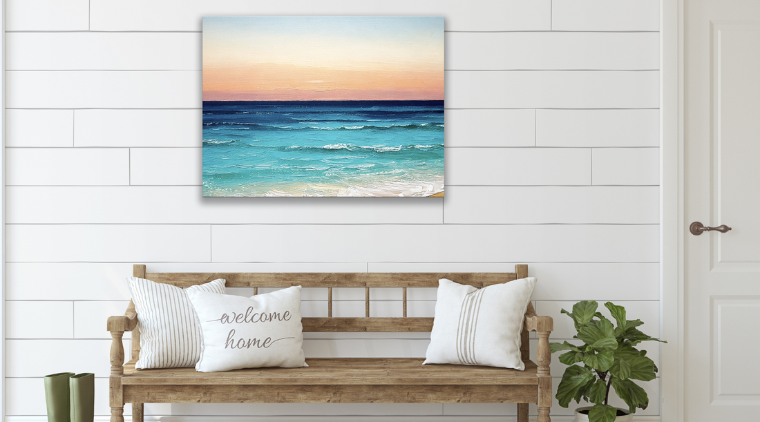 coastal sunset wall art hanging in an entryway above a bench