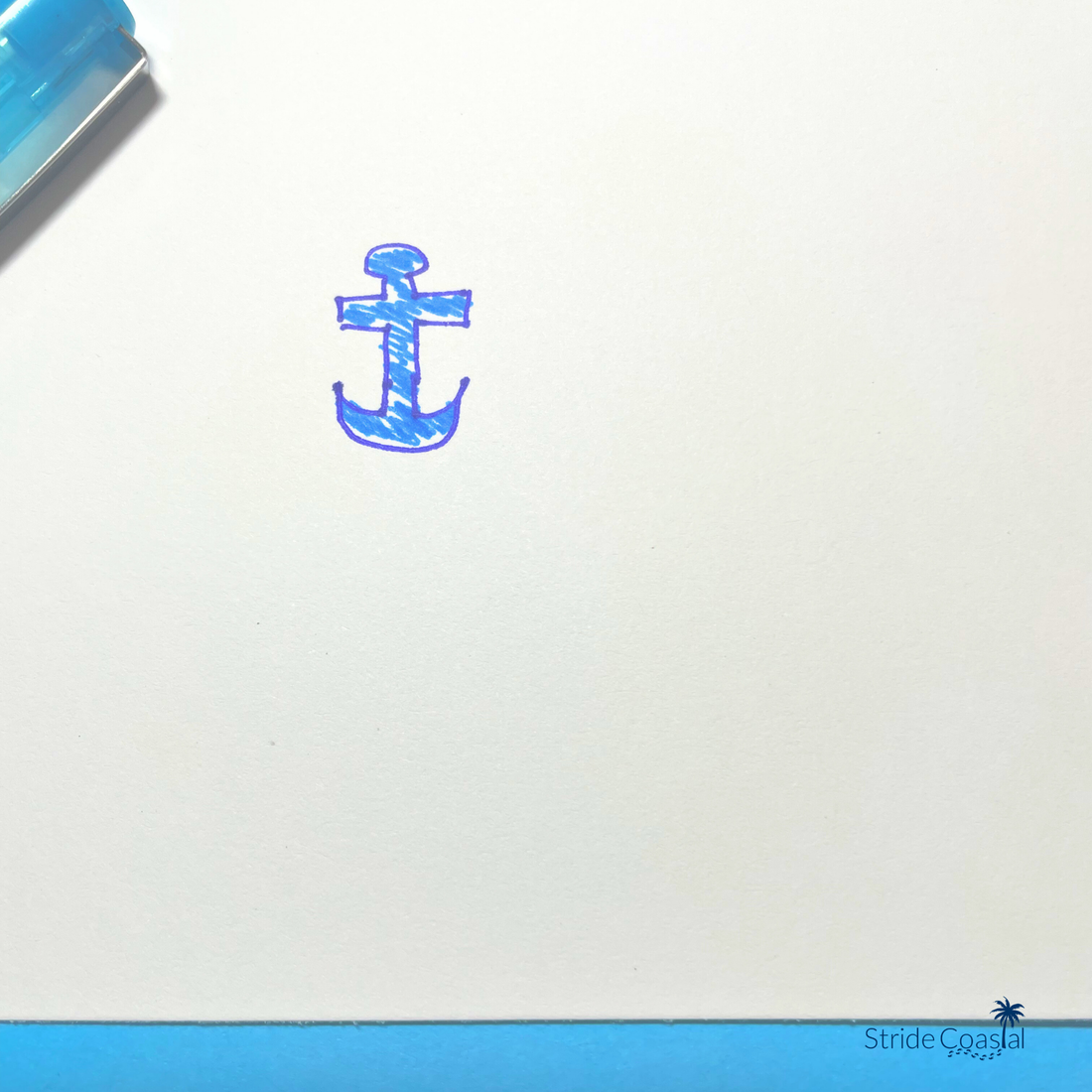 a small anchor hand drawn in blue ink