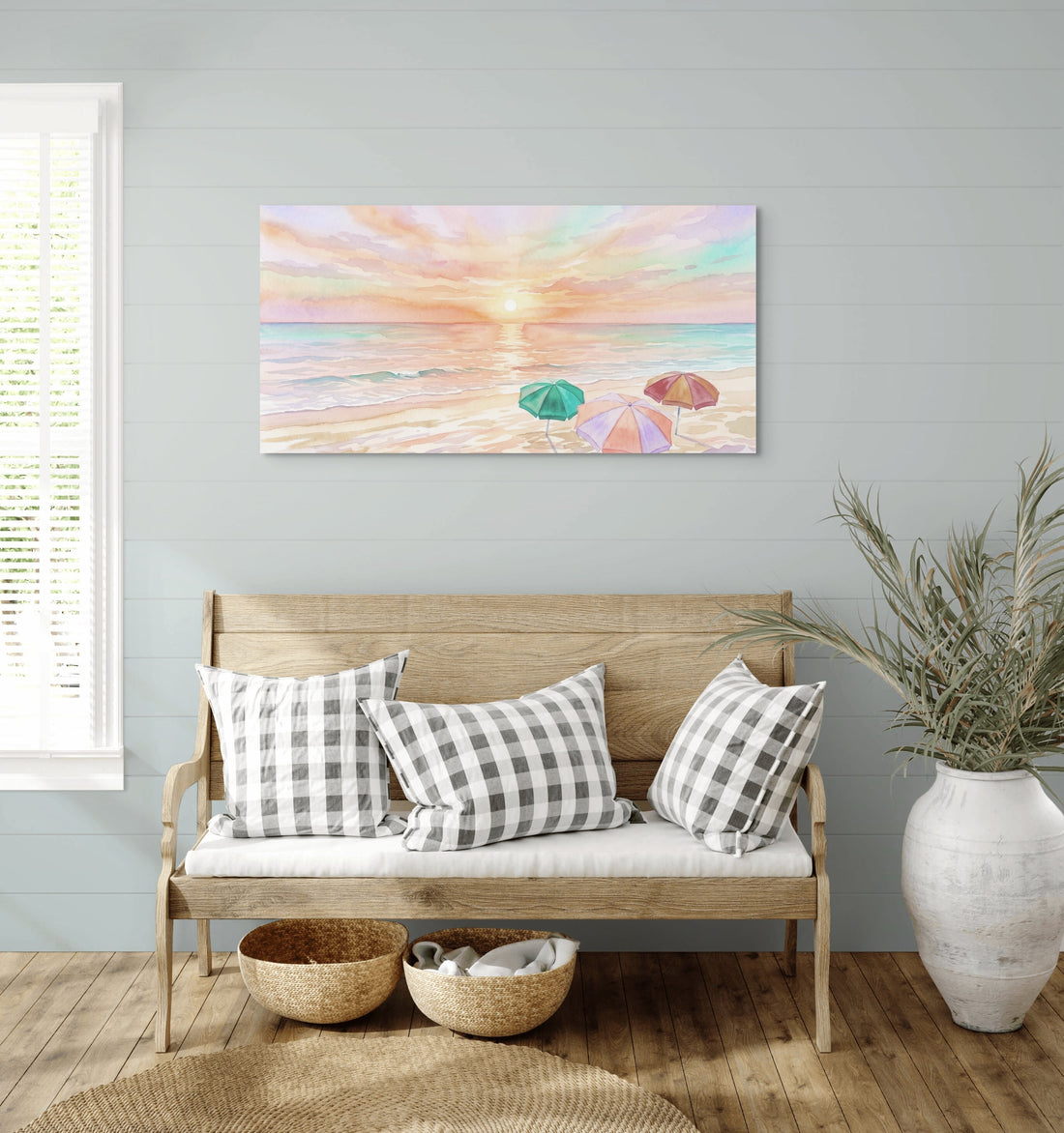 Pastel Sunset Coastal Canvas Art hanging on a wall above a wooden bench