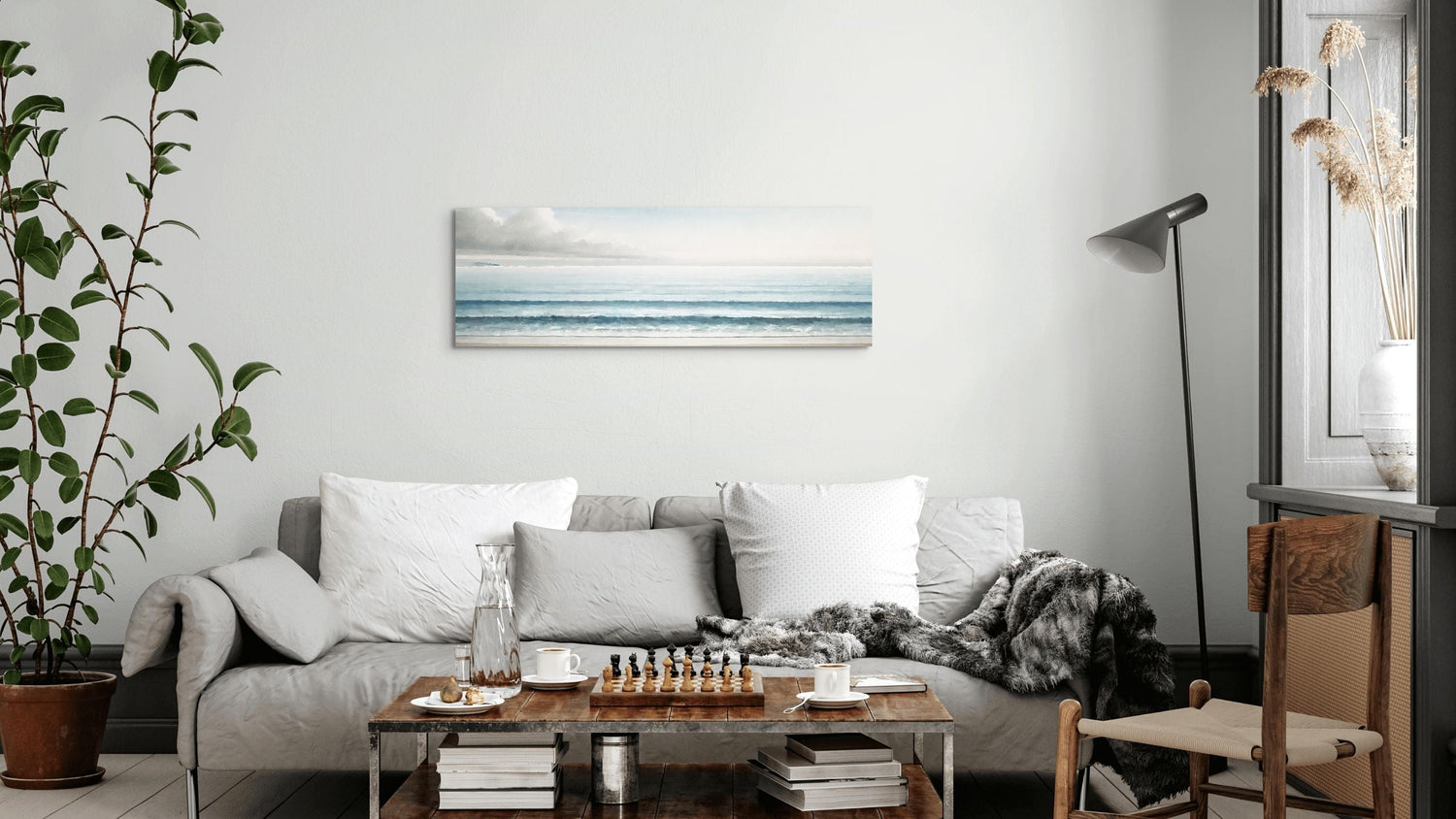 Coastal wall art, BEYOND THE BLUE, in the living room hanging above sofa