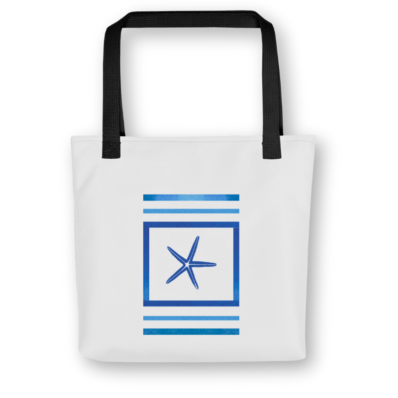 Front view of navy blue tote bag with central starfish framed by bold ocean-blue stripes, black handles, and a coastal-inspired design.
