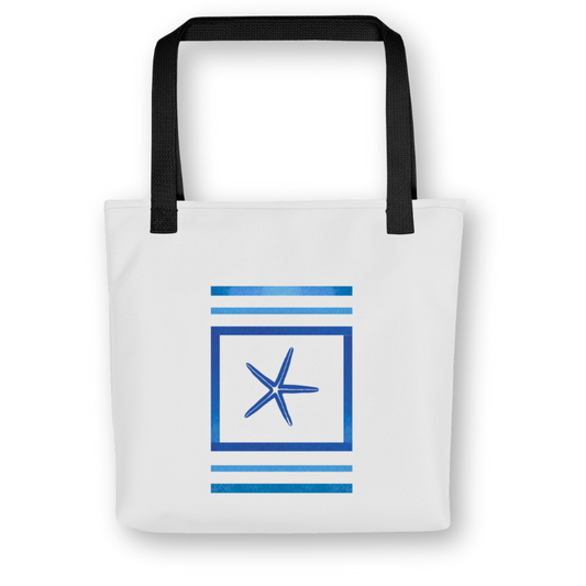 Front view of navy blue tote bag with central starfish framed by bold ocean-blue stripes, black handles, and a coastal-inspired design.
