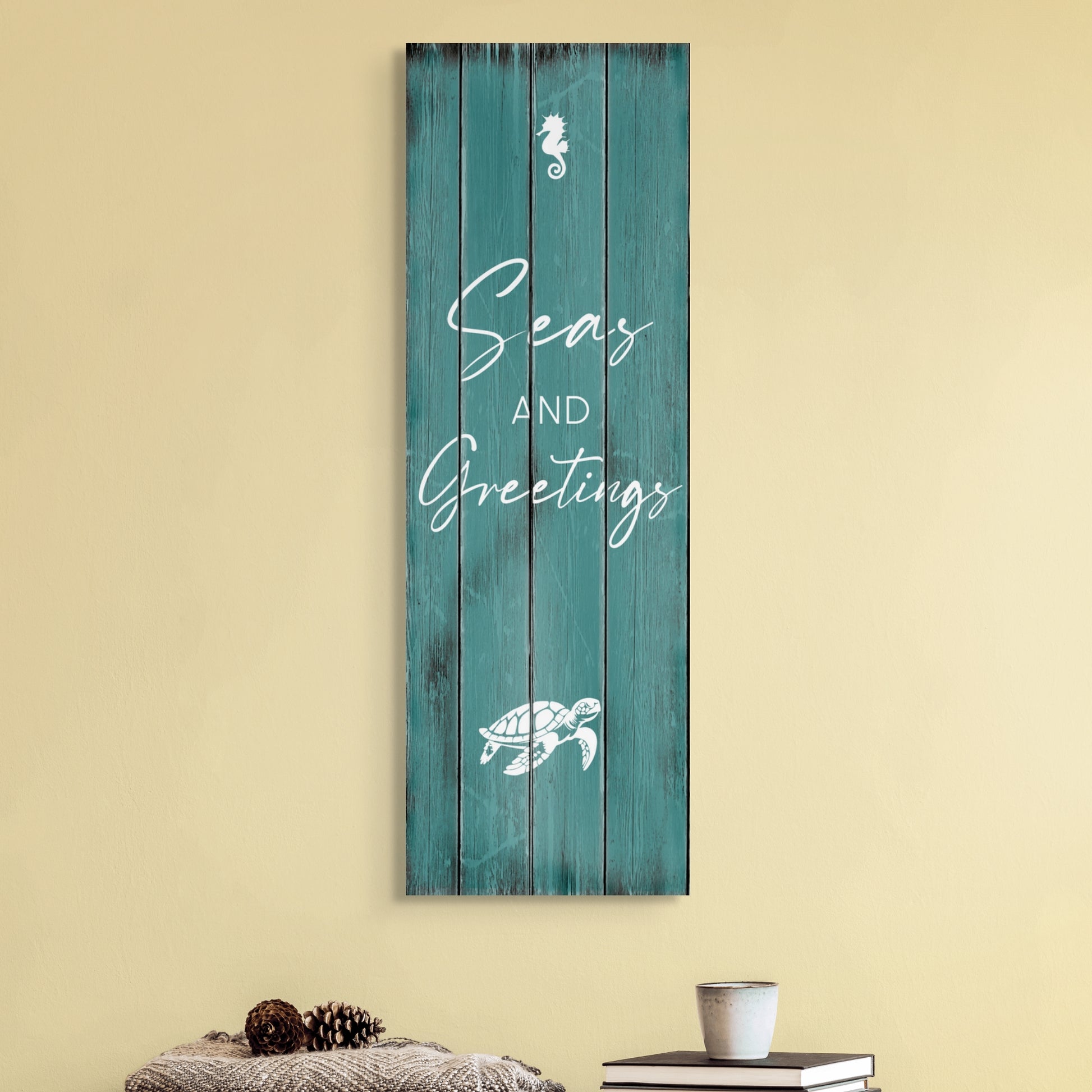 The Christmas canvas wall art SEAS AND GREETINGS. The piece hangs on a wall.
