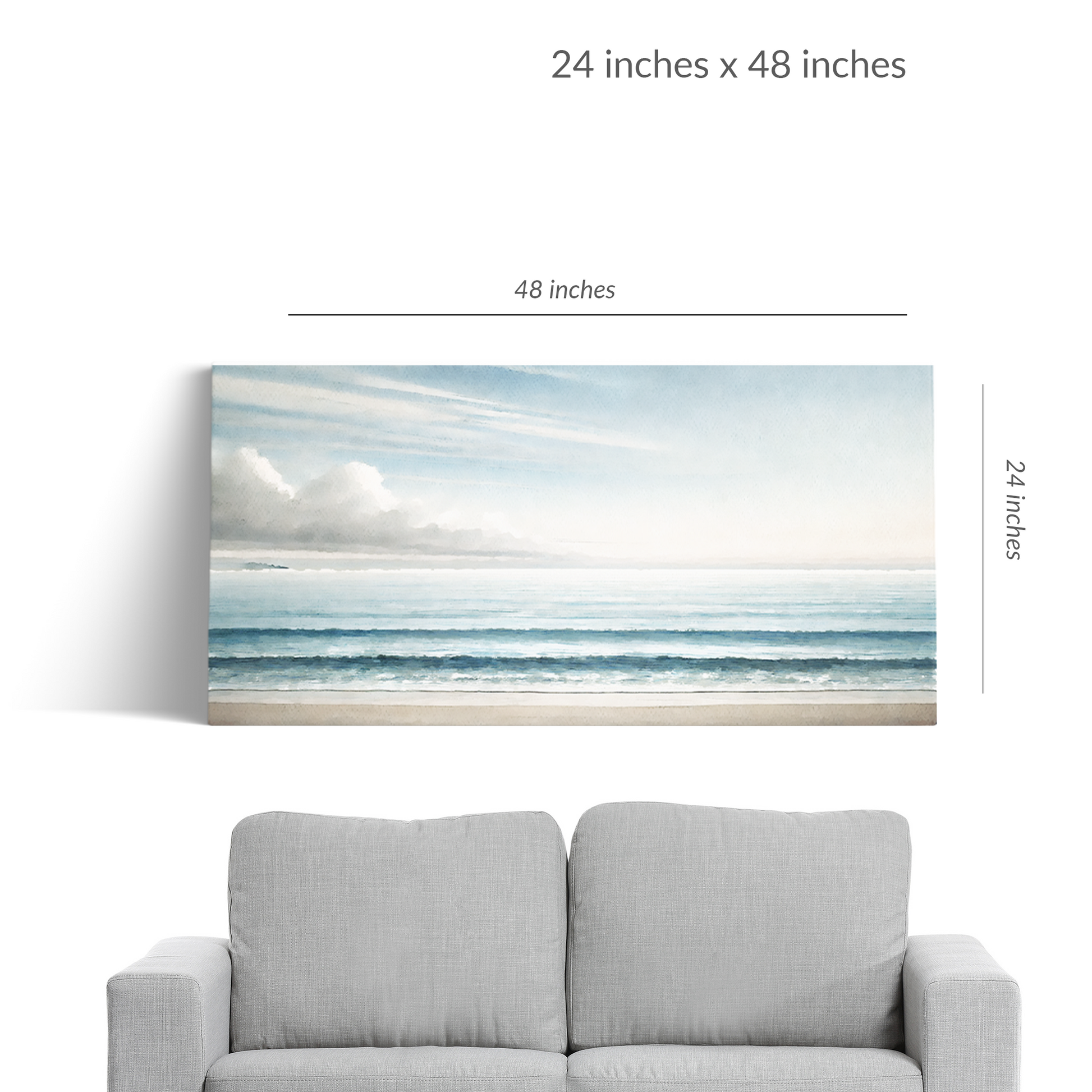 A couch under beach canvas art BEYOND THE BLUE. The seascape is in landscape orientation. Text reads: “48 inches x 24 inches”
