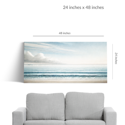 A couch under beach canvas art BEYOND THE BLUE. The seascape is in landscape orientation. Text reads: “48 inches x 24 inches”
