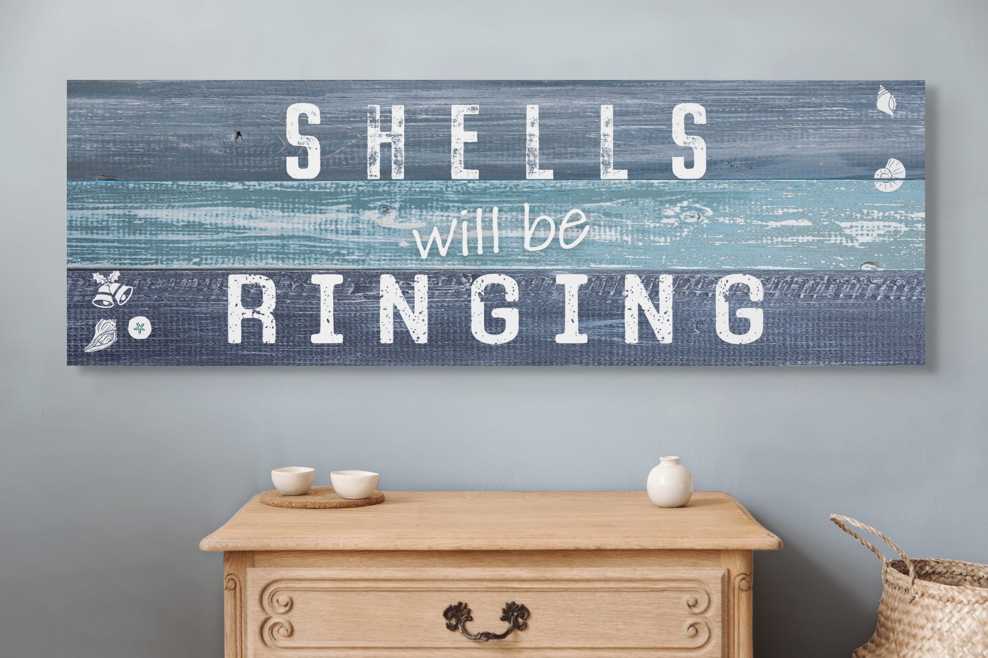 Christmas beach canvas SHELLS WILL BE RINGING. The piece hangs on a wall.
