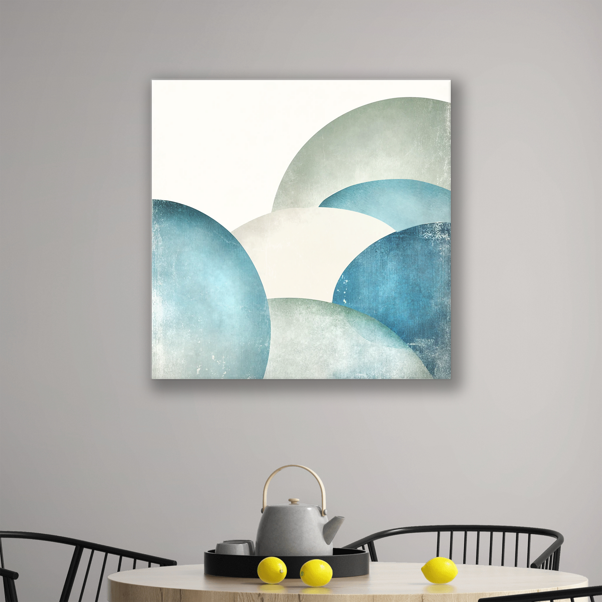 The ocean art decor on canvas MANY MOONS. The piece hangs on a wall.
