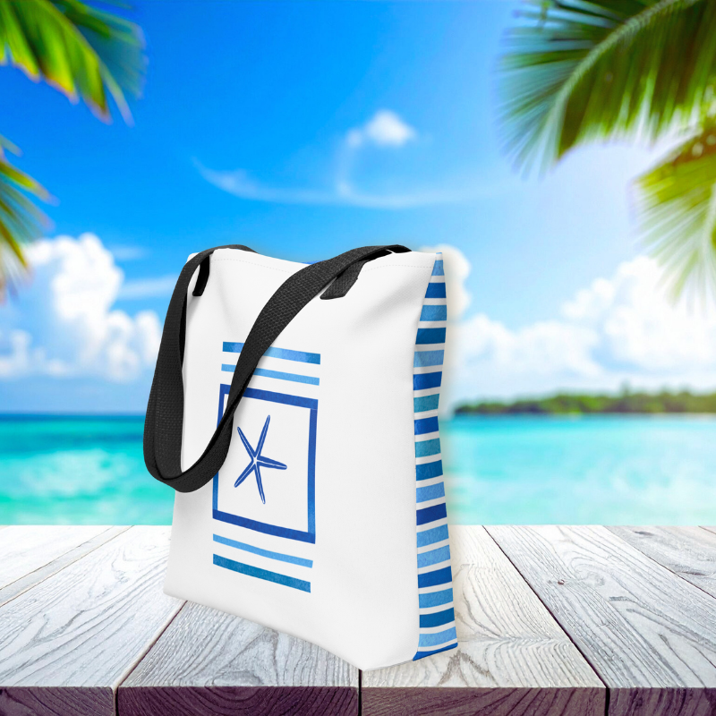 Side view of coastal bag with framed starfish motif and navy blue stripe accents, styled against a tropical ocean backdrop.
