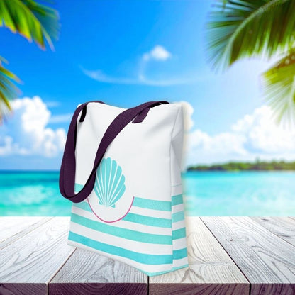 Side view of teal tote bag with turquoise seashell detail and stripe accents, styled against a tropical ocean backdrop.
