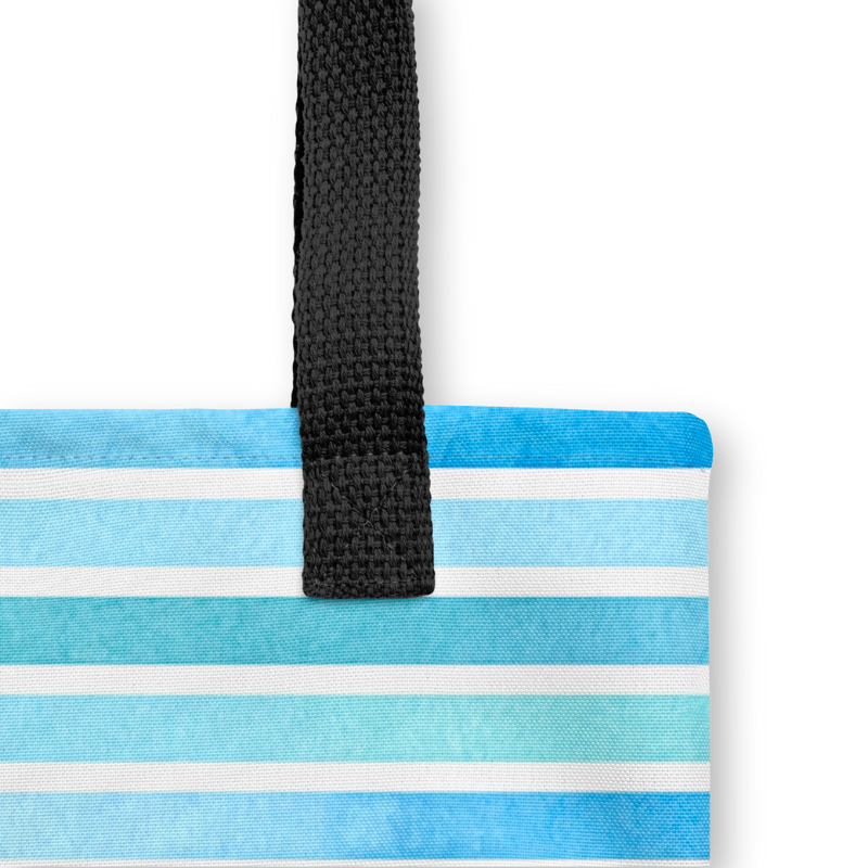 Close-up of sturdy black strap and seam stitching on the blue bag, highlighting its durable hand-sewn construction.
