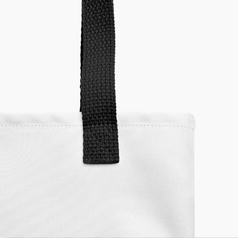Close-up of sturdy black strap and seam stitching on the blue tote handbag, highlighting its durable hand-sewn construction.
