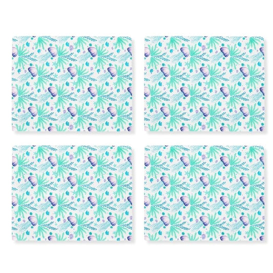 Four matching coastal placemats with an ocean-themed jellyfish pattern on a white background