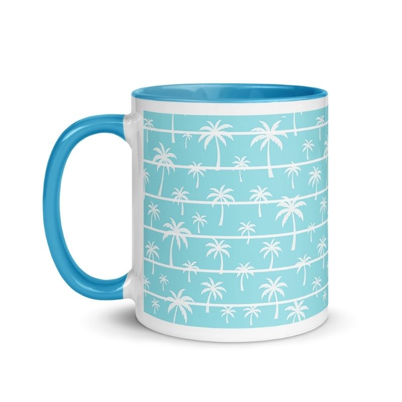 Palm tree pattern coffee mug with blue handle, tropical white palms on mint green background, beach vacation themed cup