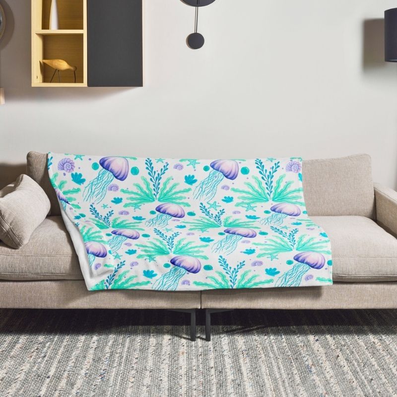 Jelly Drift Aqua & Lavender Throw Blanket displayed on sofa — cozy coastal throw for living room decor
